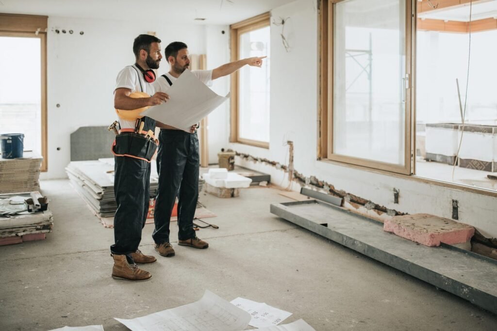 Two ALHUD engineers reviewing renovation drawings during an Abu Dhabi site survey